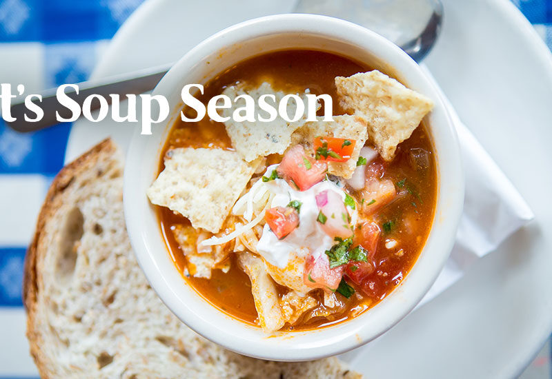 Bowl of Taco Soup with a slice of fresh bead on Merridee's blue gingham tablecloth